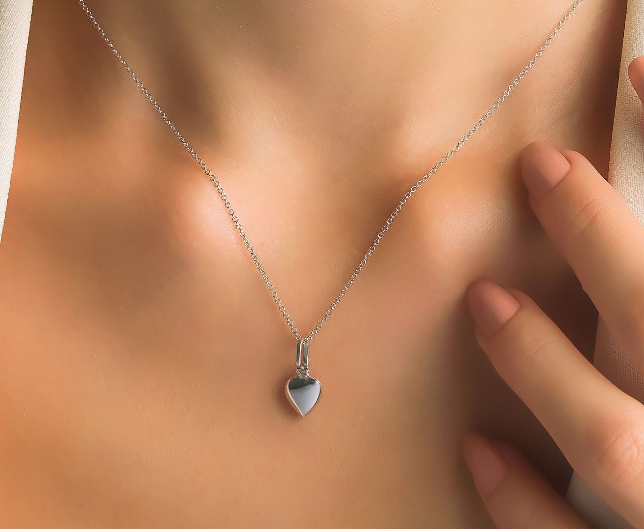 14K white gold shiny puffed heart necklace worn on a model, showcasing elegance and simplicity for everyday use.