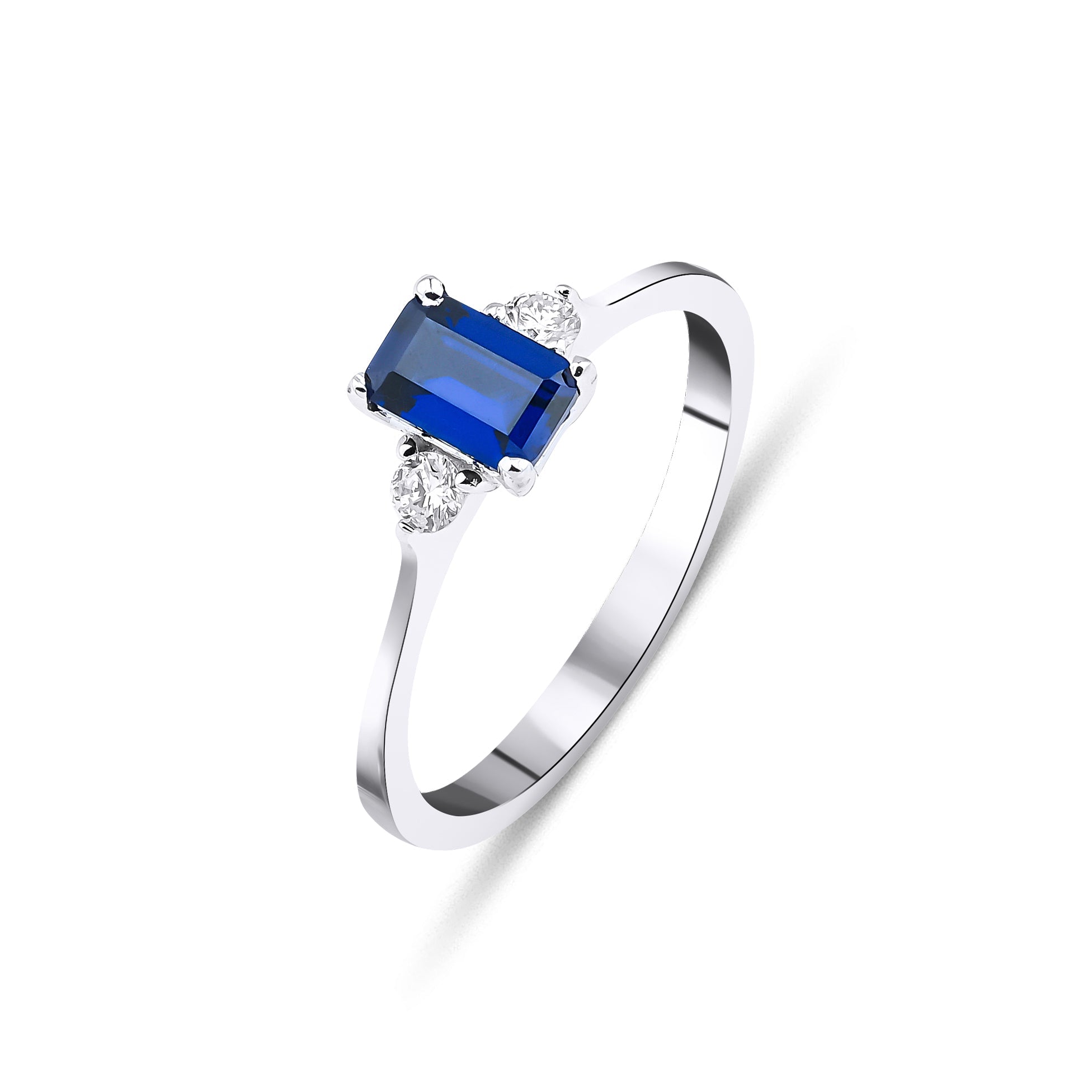 14K white gold ring featuring an emerald cut sapphire and two round diamonds, showcasing elegance and luxury.