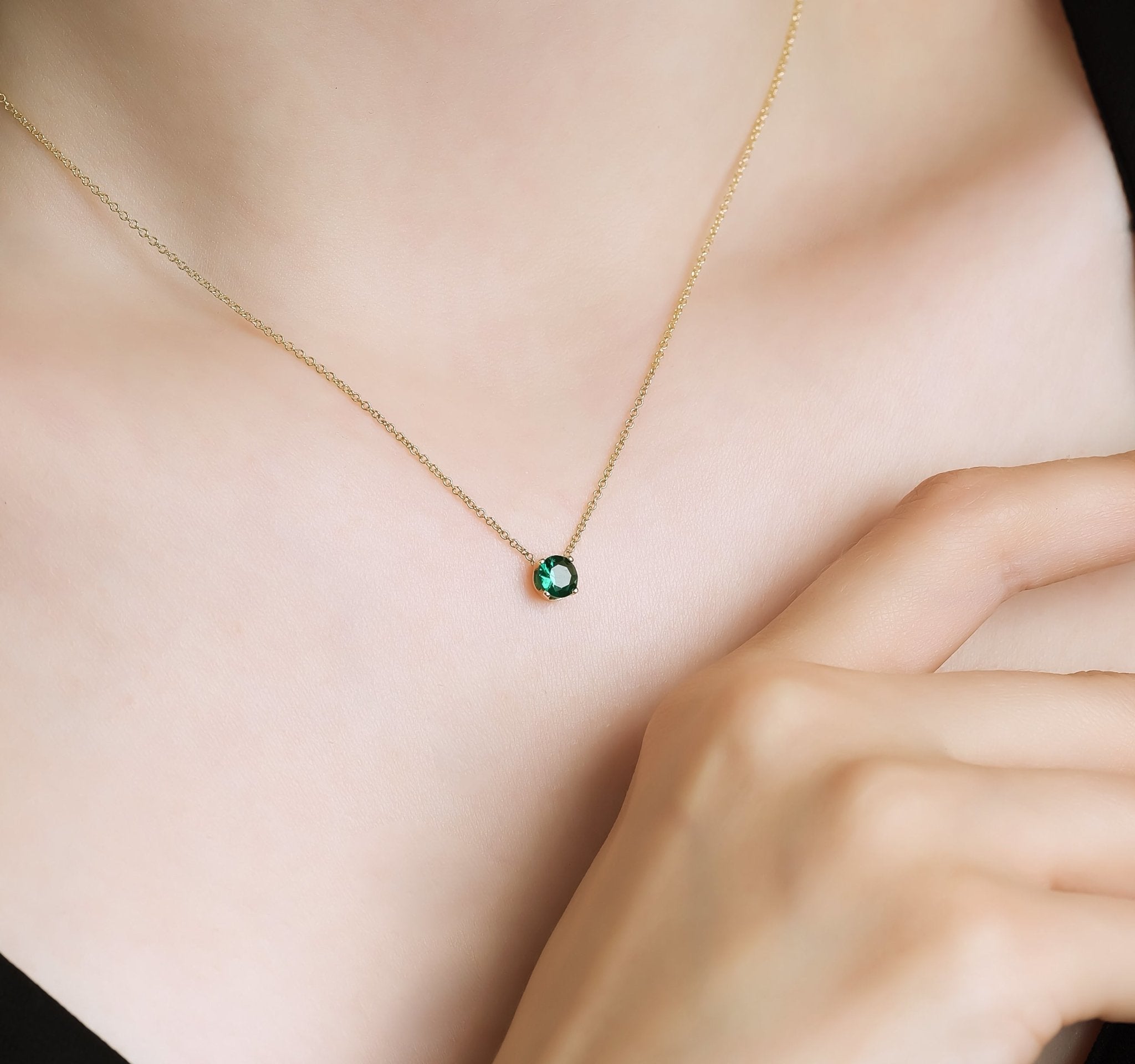 Minimalist 14K yellow gold 5mm prong setting solitaire emerald necklace worn on neck, perfect for everyday elegance.