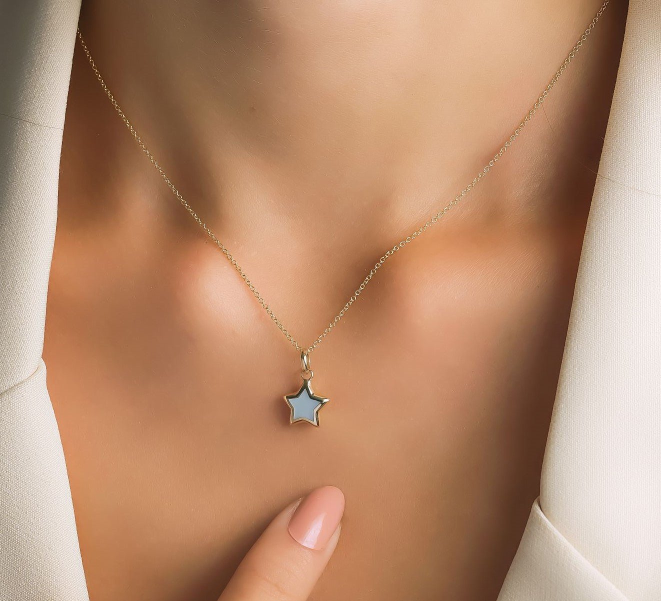 14K yellow gold minimalist mother of pearl star necklace worn on a model's neck, showcasing elegant and dainty design.