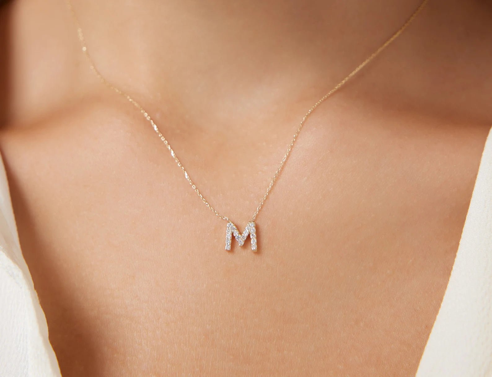 14K yellow gold diamond initial necklace featuring a sparkling letter M, ideal for personal touch and elegance.