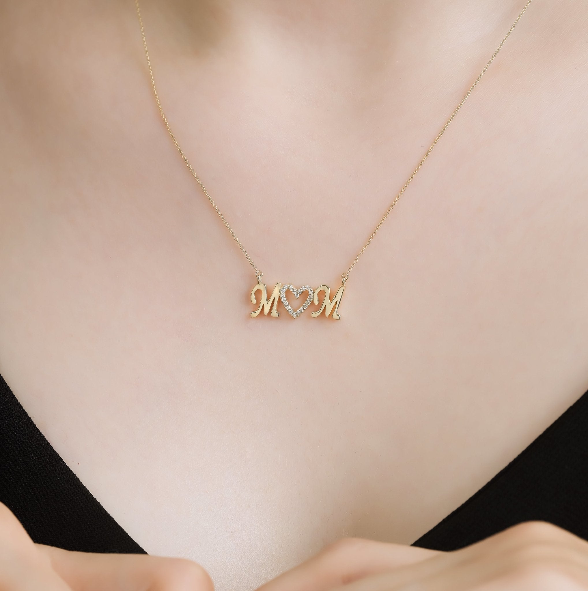 14K yellow gold diamond Mom necklace showcased on a model, perfect Mother's Day gift, delicate and stylish.