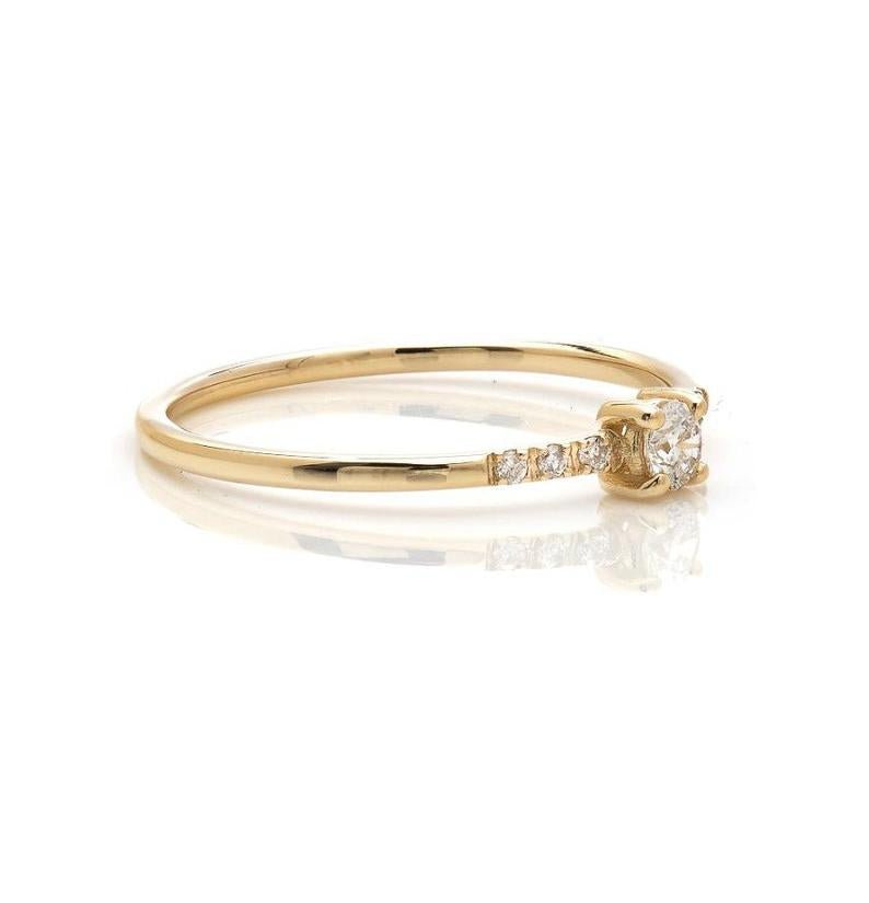 14K yellow gold minimalist solitaire diamond engagement ring with a central 3mm diamond and side diamonds, perfect for everyday wear.