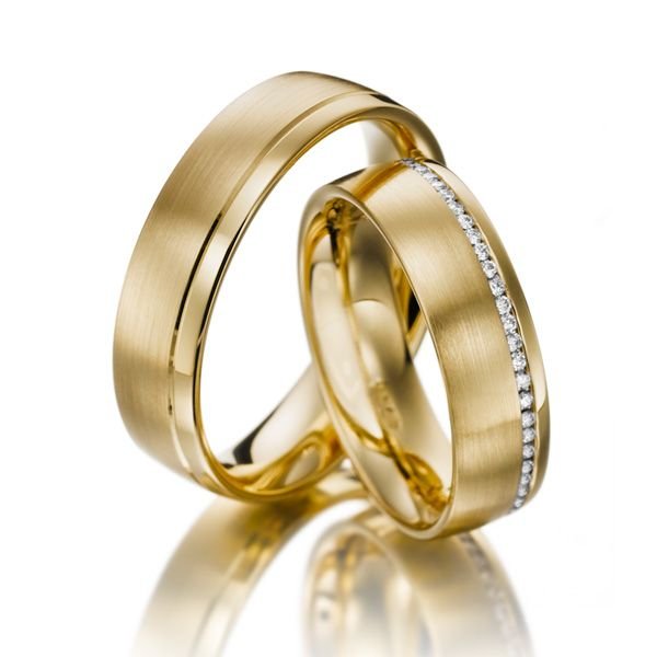 His and Hers diamond eternity wedding bands in 10K yellow gold with satin finish and round cut diamonds.