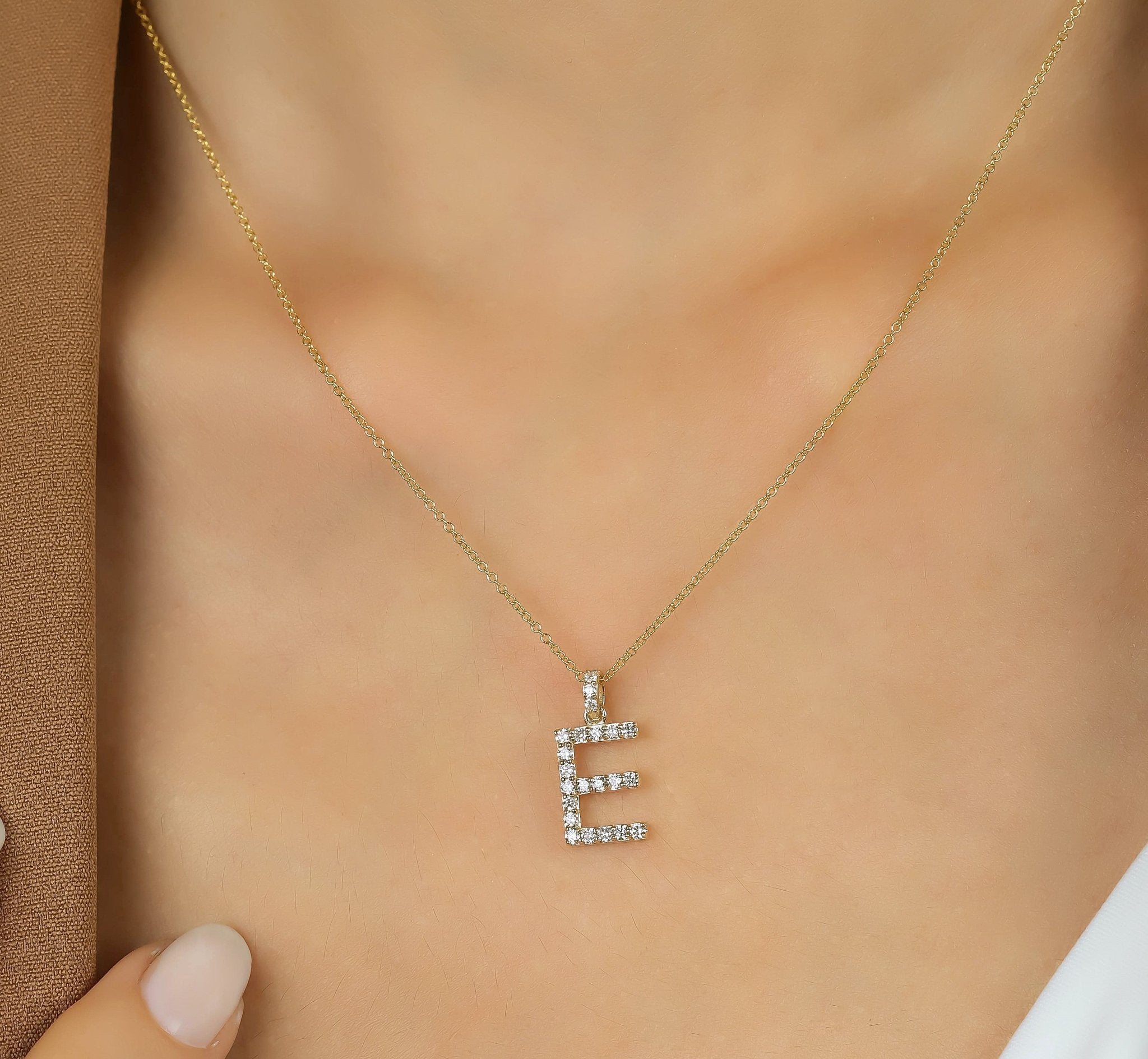 14K yellow gold diamond initial necklace featuring the letter E, showcasing sparkling natural diamonds.