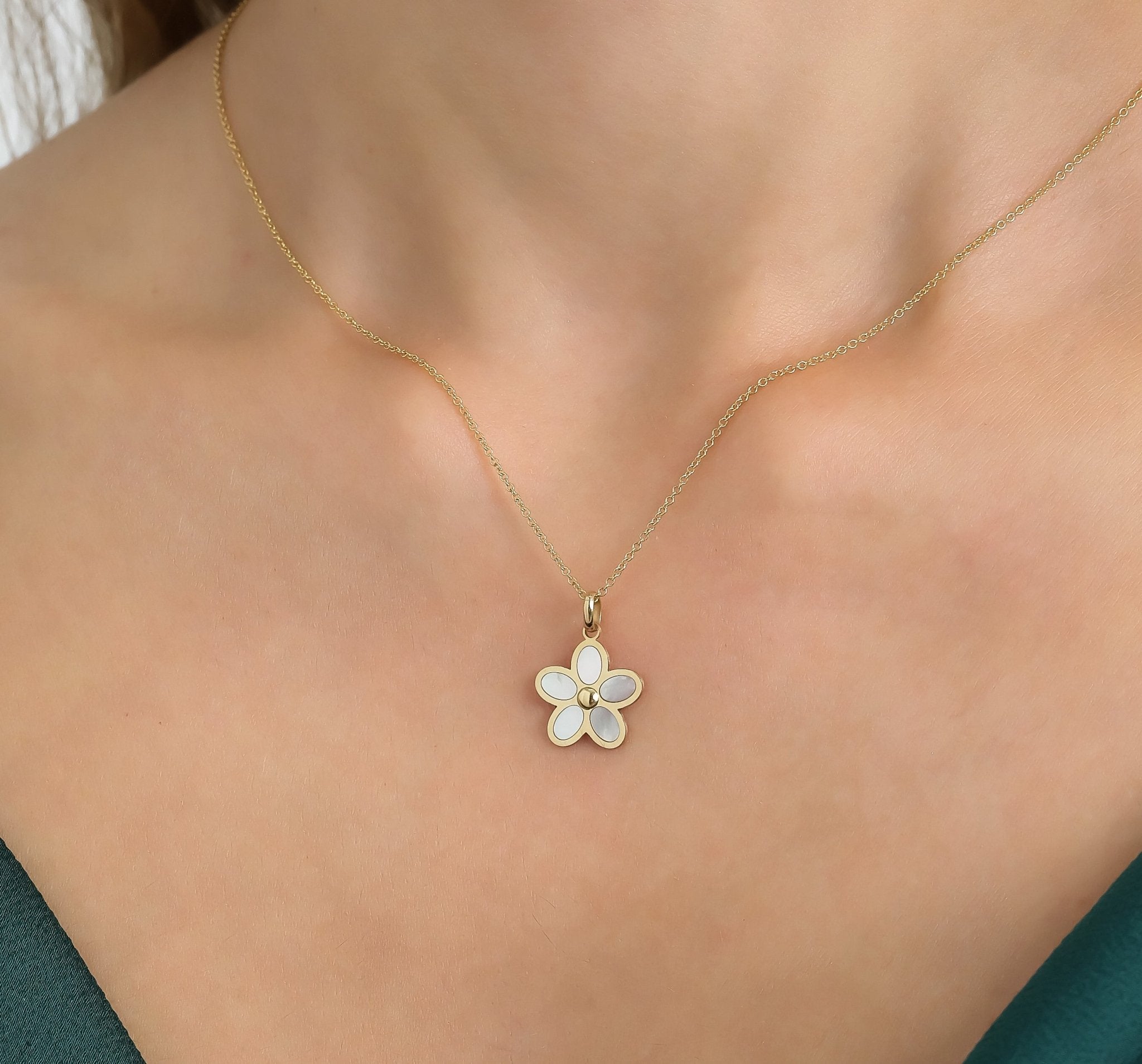 Dainty 14K yellow gold daisy flower necklace with mother of pearl pendant, perfect for everyday elegance.