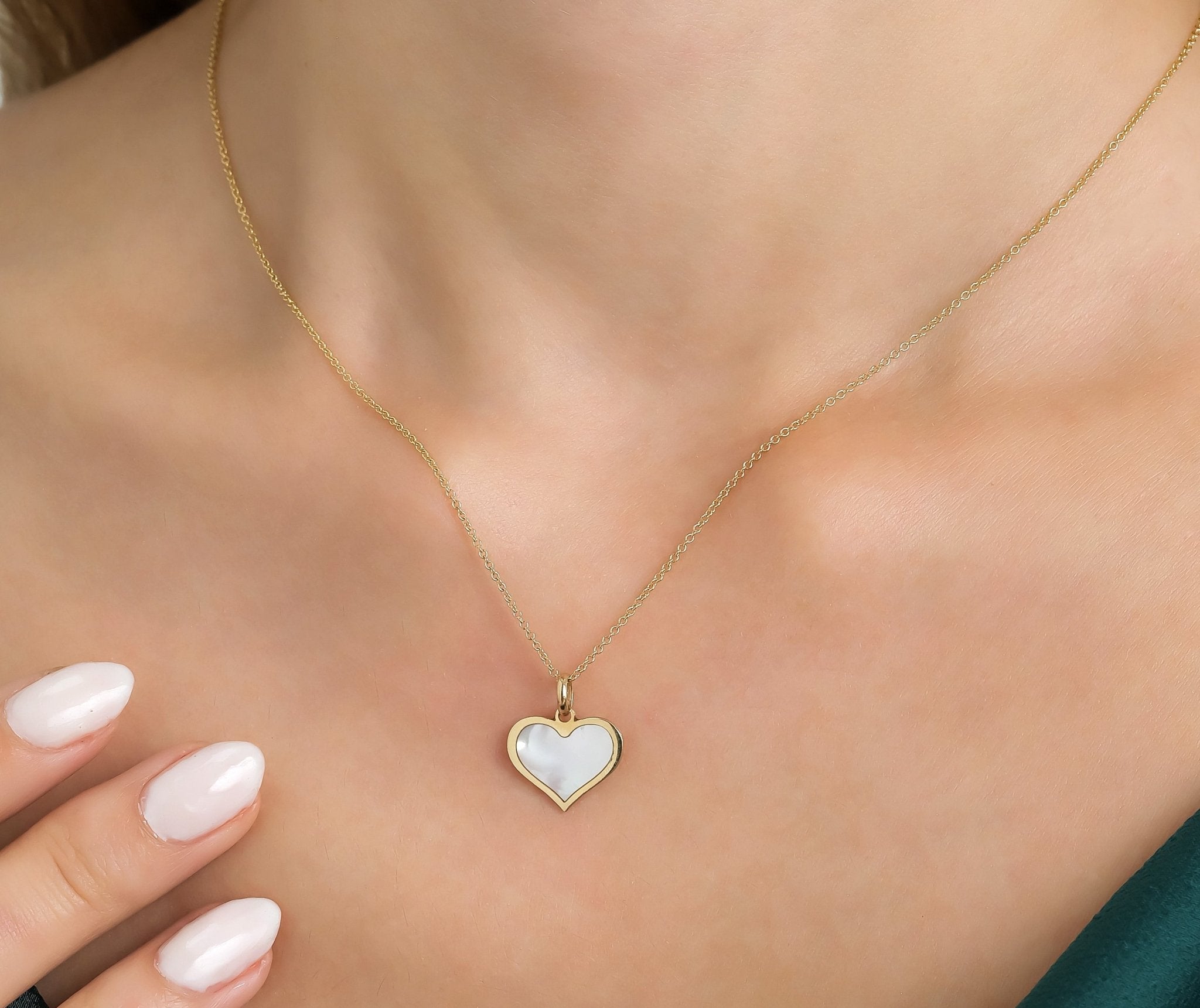 14K yellow gold heart necklace with natural mother of pearl pendant, perfect for everyday elegance.