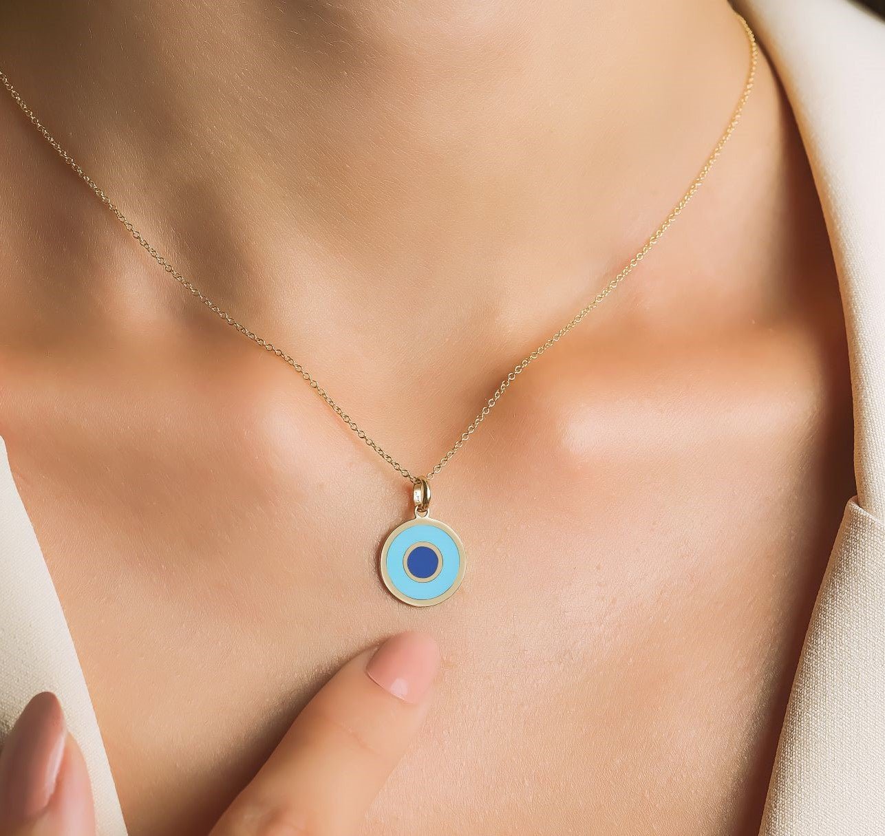 Dainty 14K yellow gold round turquoise evil eye necklace worn on neck, perfect for everyday wear.