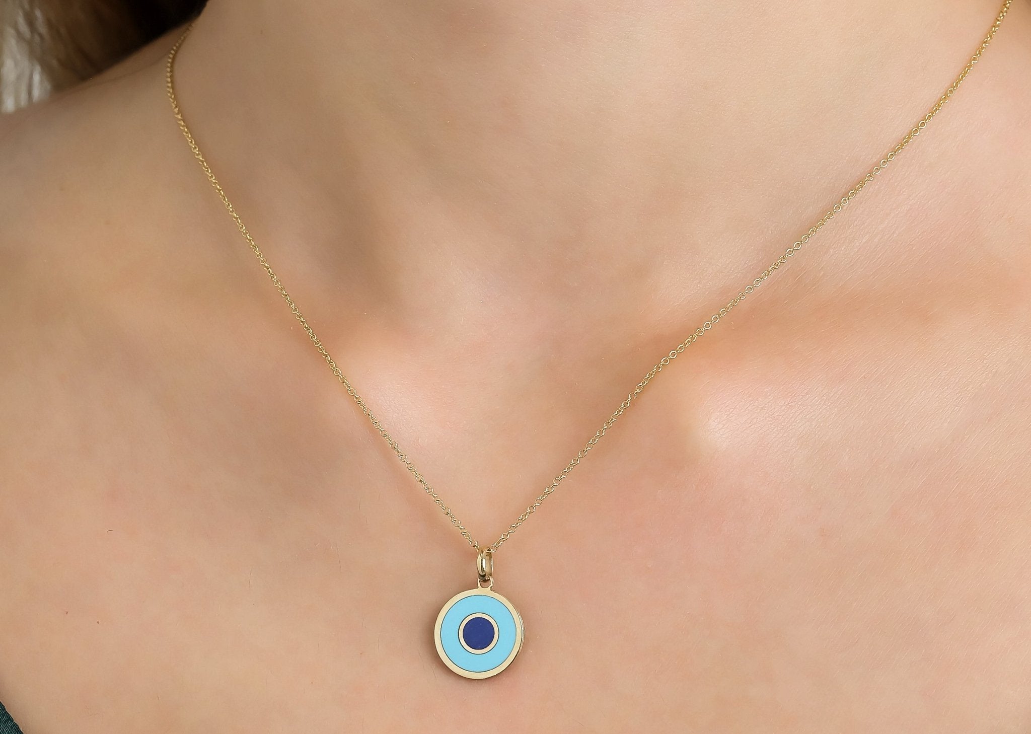 14K yellow gold necklace featuring a round turquoise evil eye pendant, classy and dainty design for everyday wear.