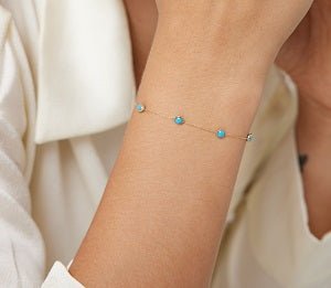 14K yellow gold beaded station turquoise bracelet worn on wrist, simple elegant design for everyday use.