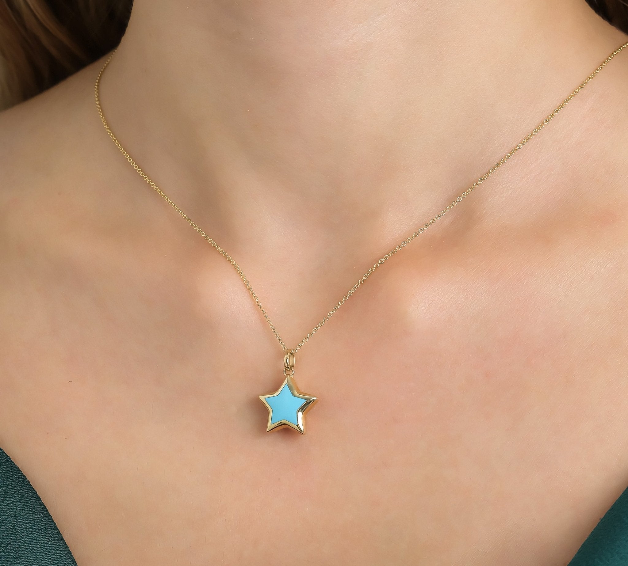 14K yellow gold turquoise puffed star necklace worn on a woman's neck, showcasing its dainty and elegant design.
