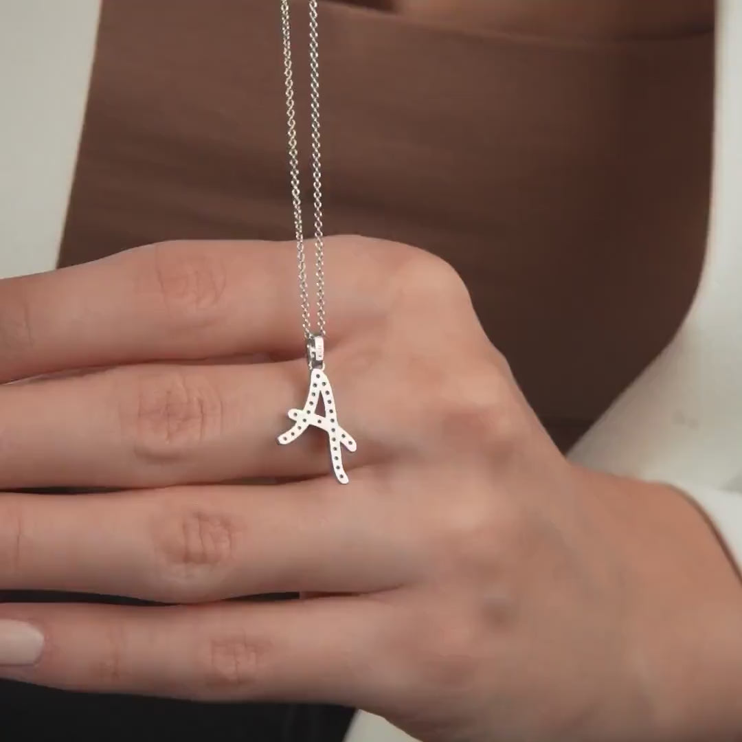 14K solid white gold initial necklace with diamond accents, featuring the letter A, displayed on a hand.