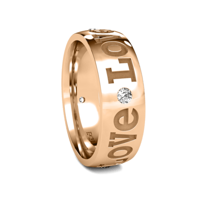 Rose gold wedding band with 'love' engraving and a round diamond accent, symbolizing everlasting commitment.