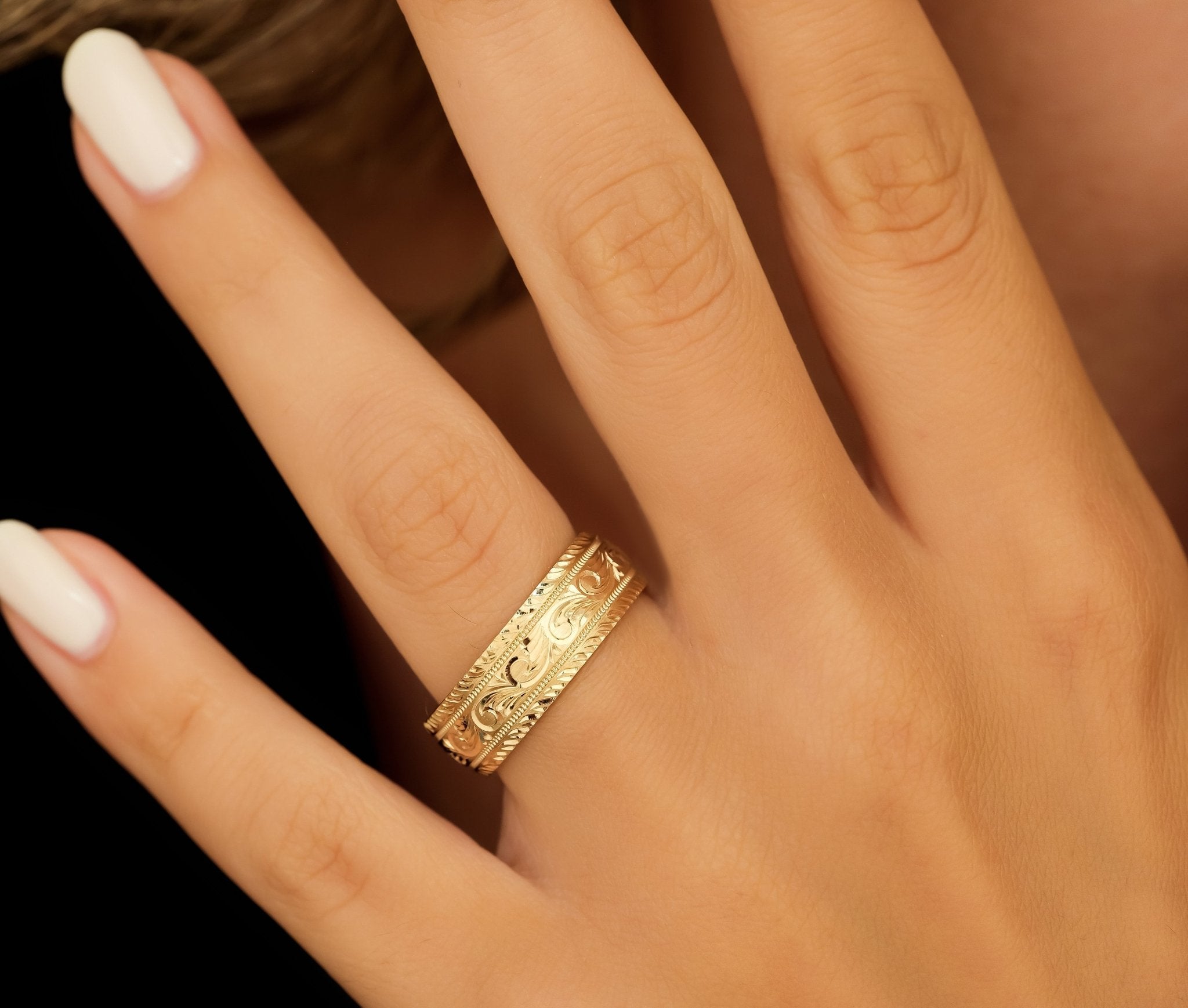 Hand engraved solid yellow gold men's wedding band, 7mm wide, featuring stunning leaf motif design.