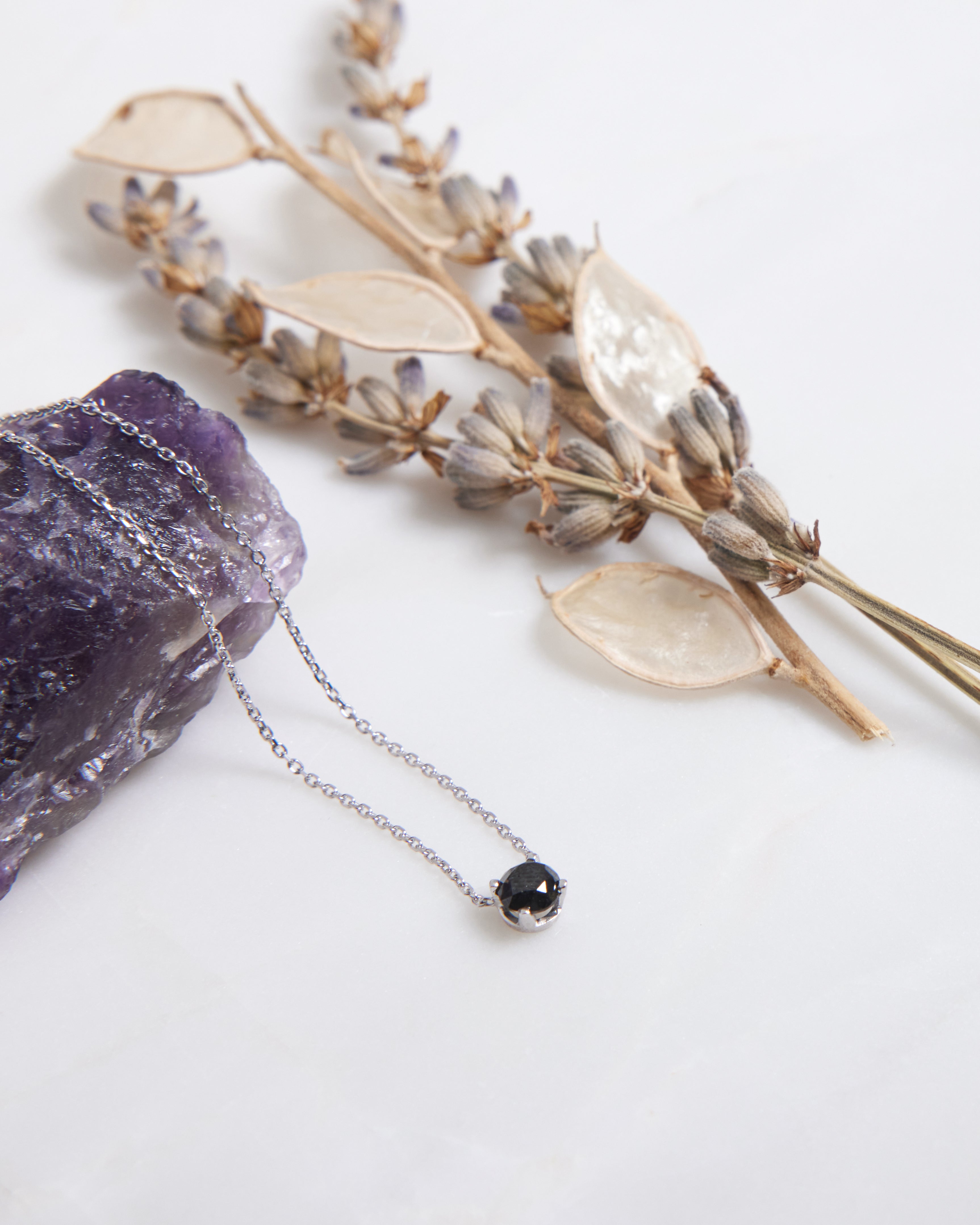 14K white gold black diamond solitaire necklace on amethyst with dried flowers, minimalist jewelry for everyday wear.