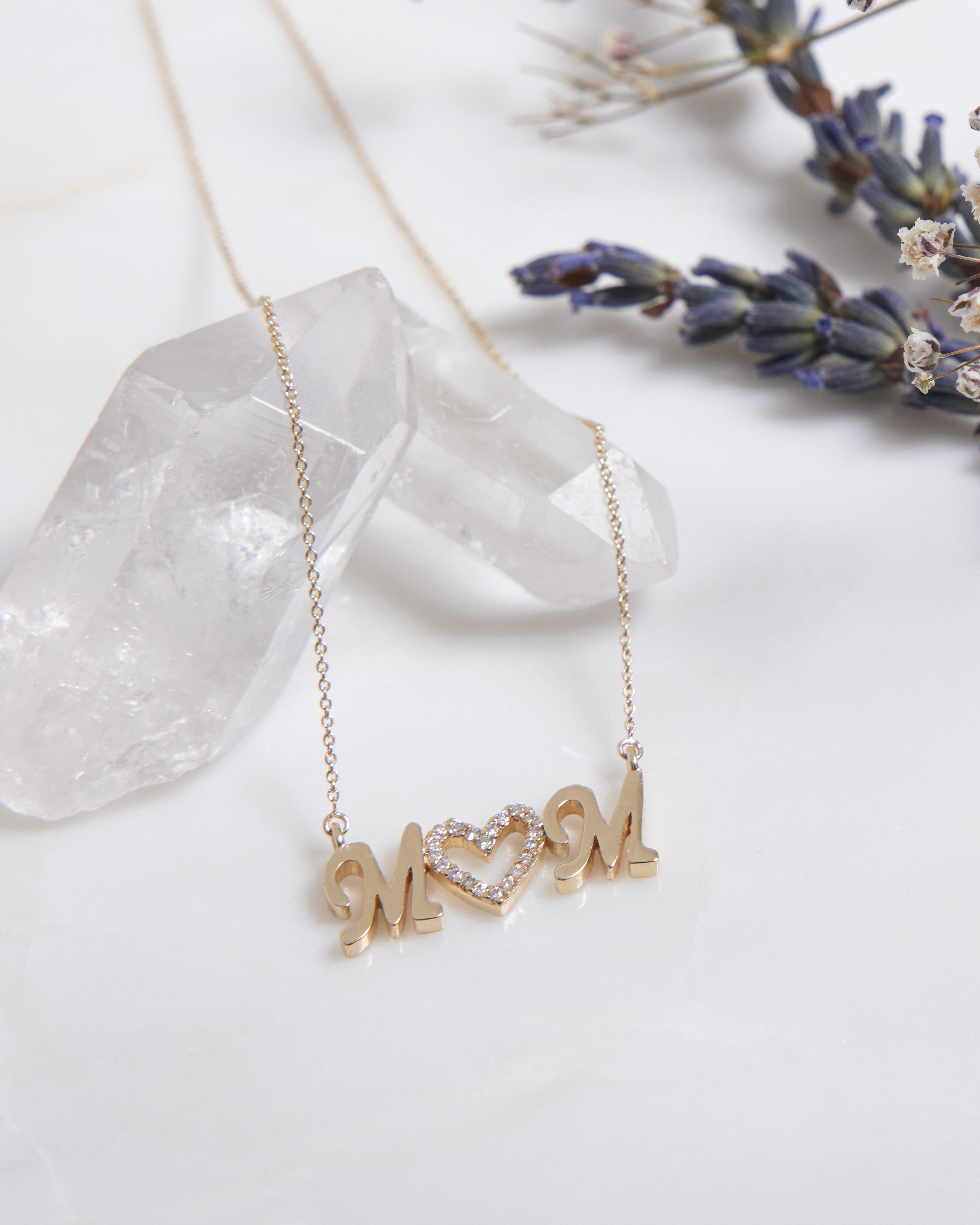 14K yellow gold necklace with 'MOM' pendant and diamond heart, perfect Mother's Day gift.