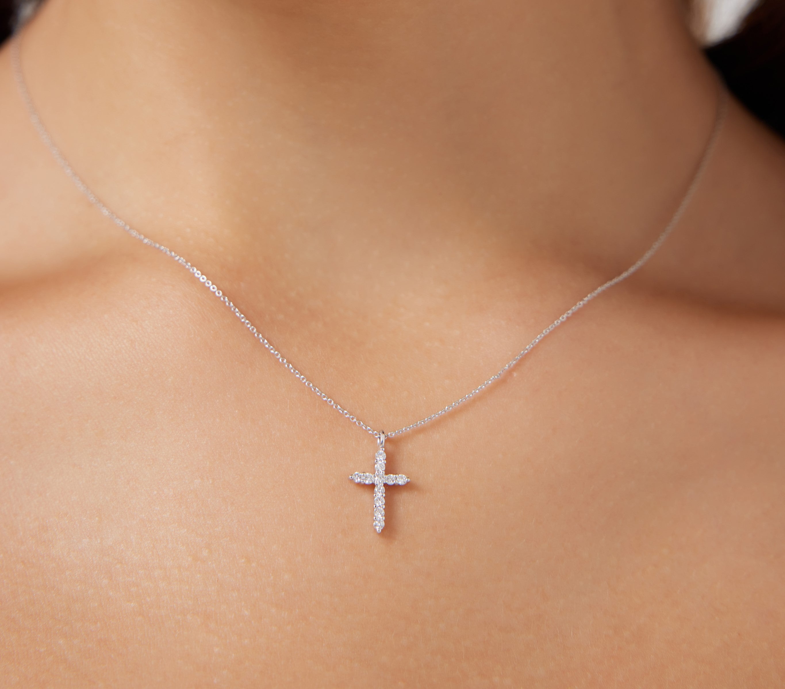 14K solid white gold diamond cross necklace showcased on a model's neck, featuring a minimalist design and sparkling diamonds.