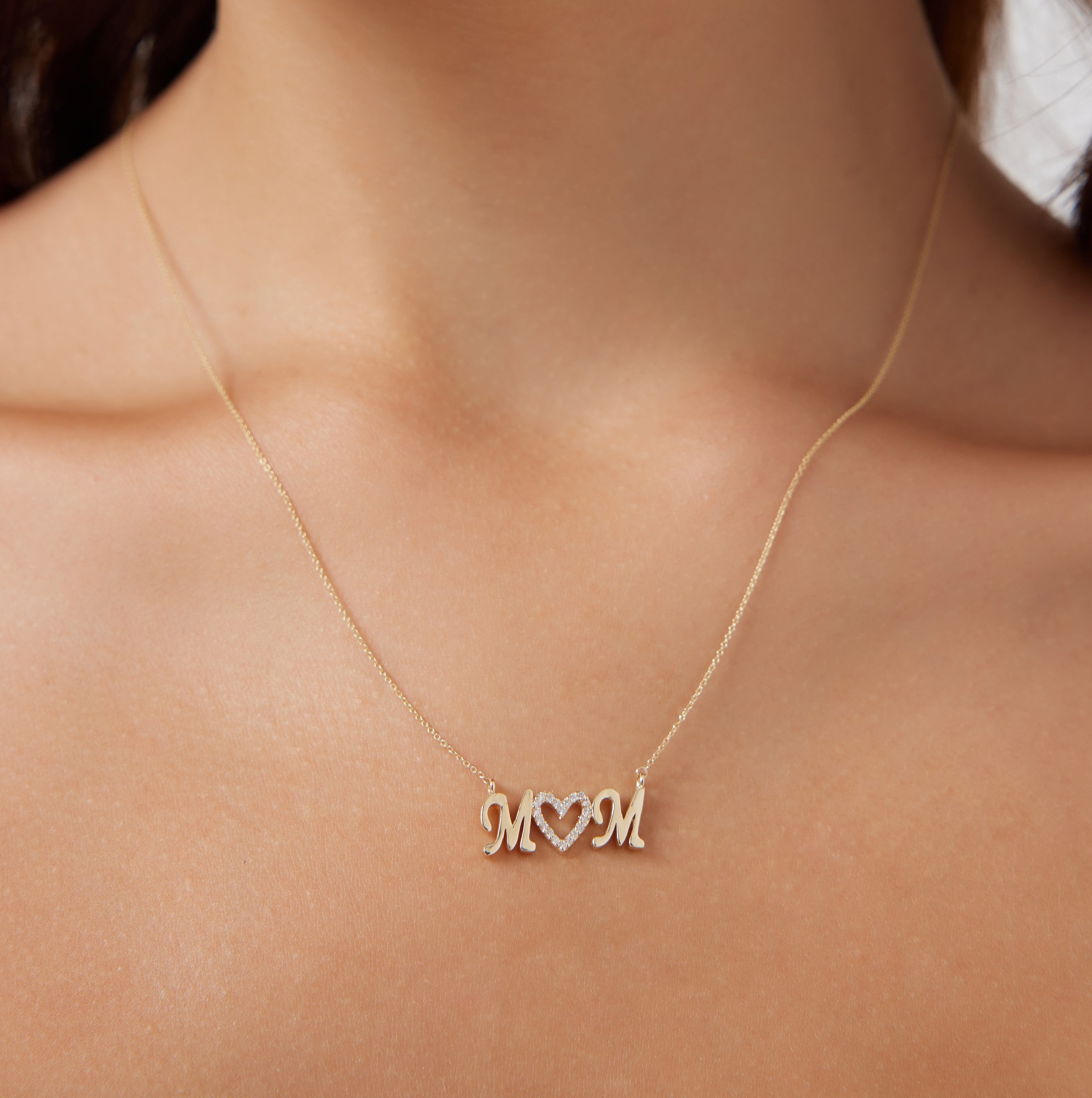 14K yellow gold mom necklace featuring diamond accents, a delicate design perfect for Mother's Day gifts.