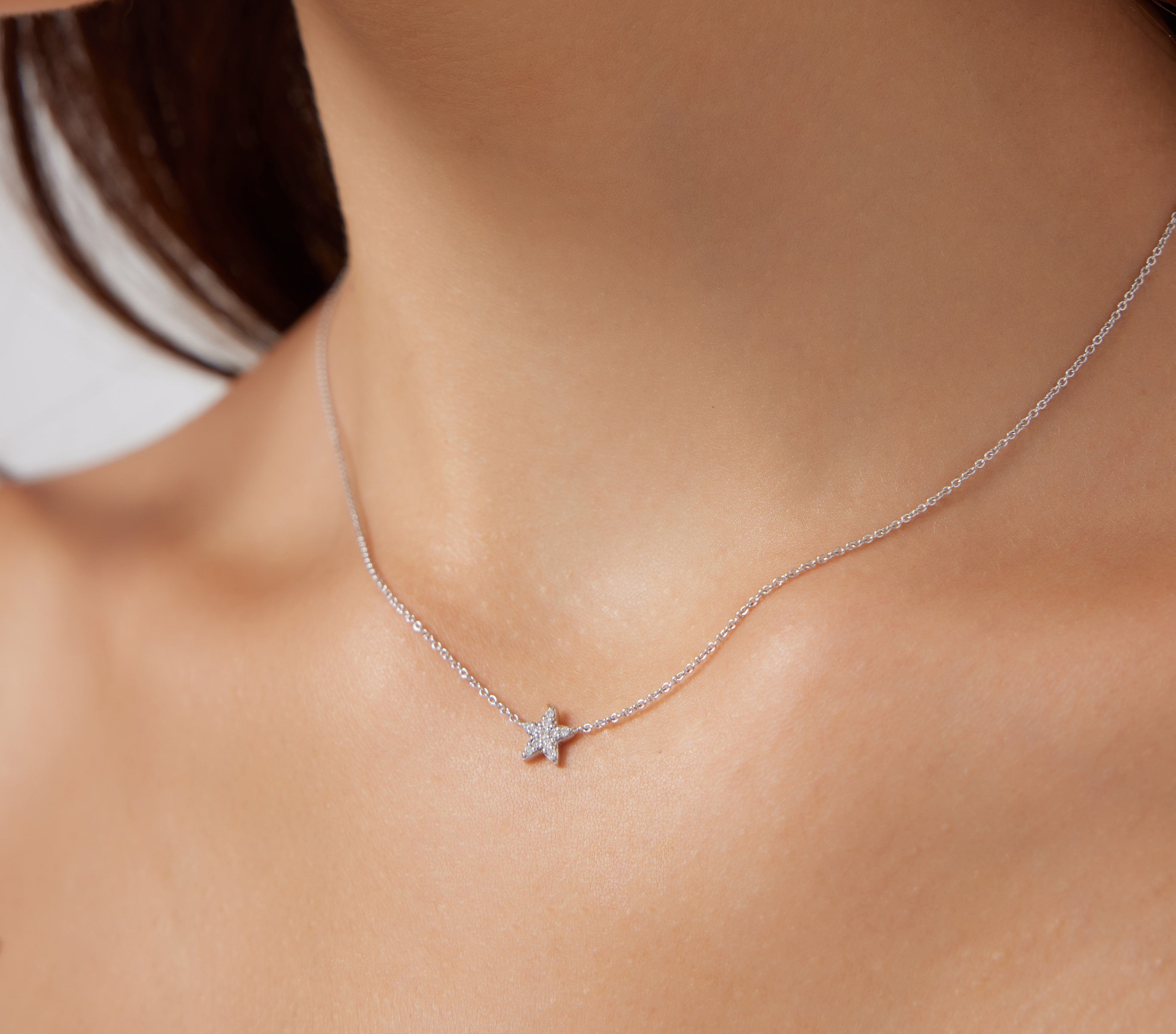 14K solid white gold diamond star necklace worn on a woman's neck, showcasing a minimalist design and delicate sparkle.