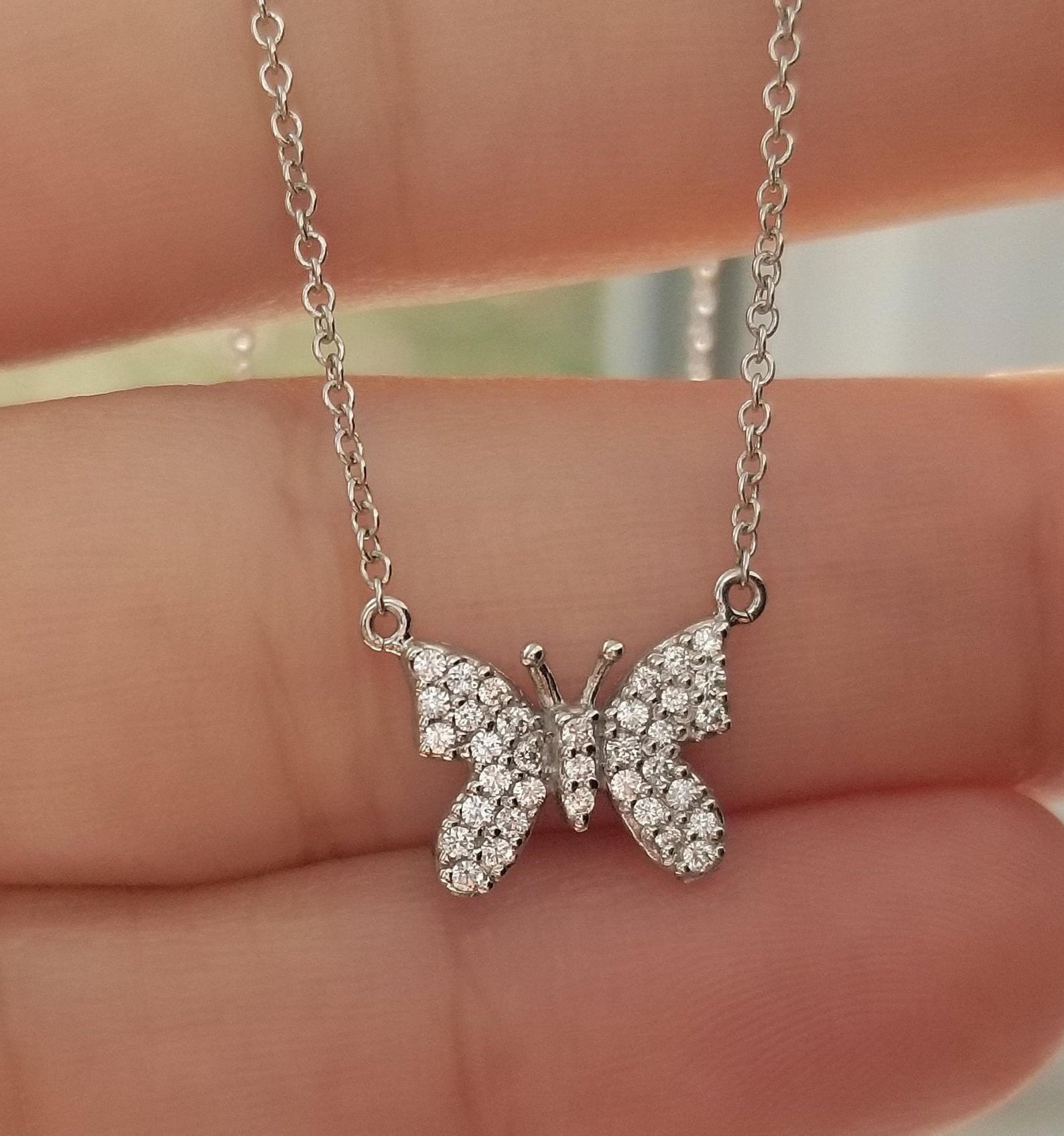 14K solid white gold butterfly necklace with 35 sparkling diamonds, 16-inch chain, 9mm height, and 10.75mm width.