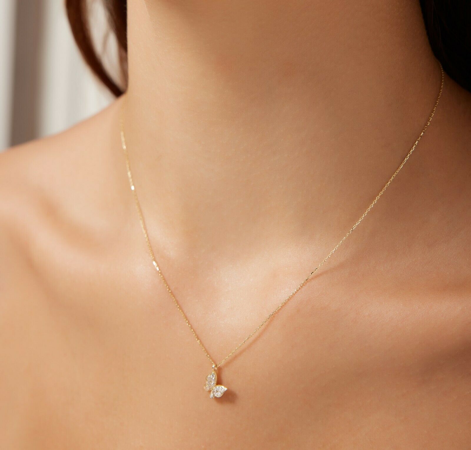 14K solid yellow gold minimalist butterfly necklace with diamond CZ, showcasing elegance and simplicity.