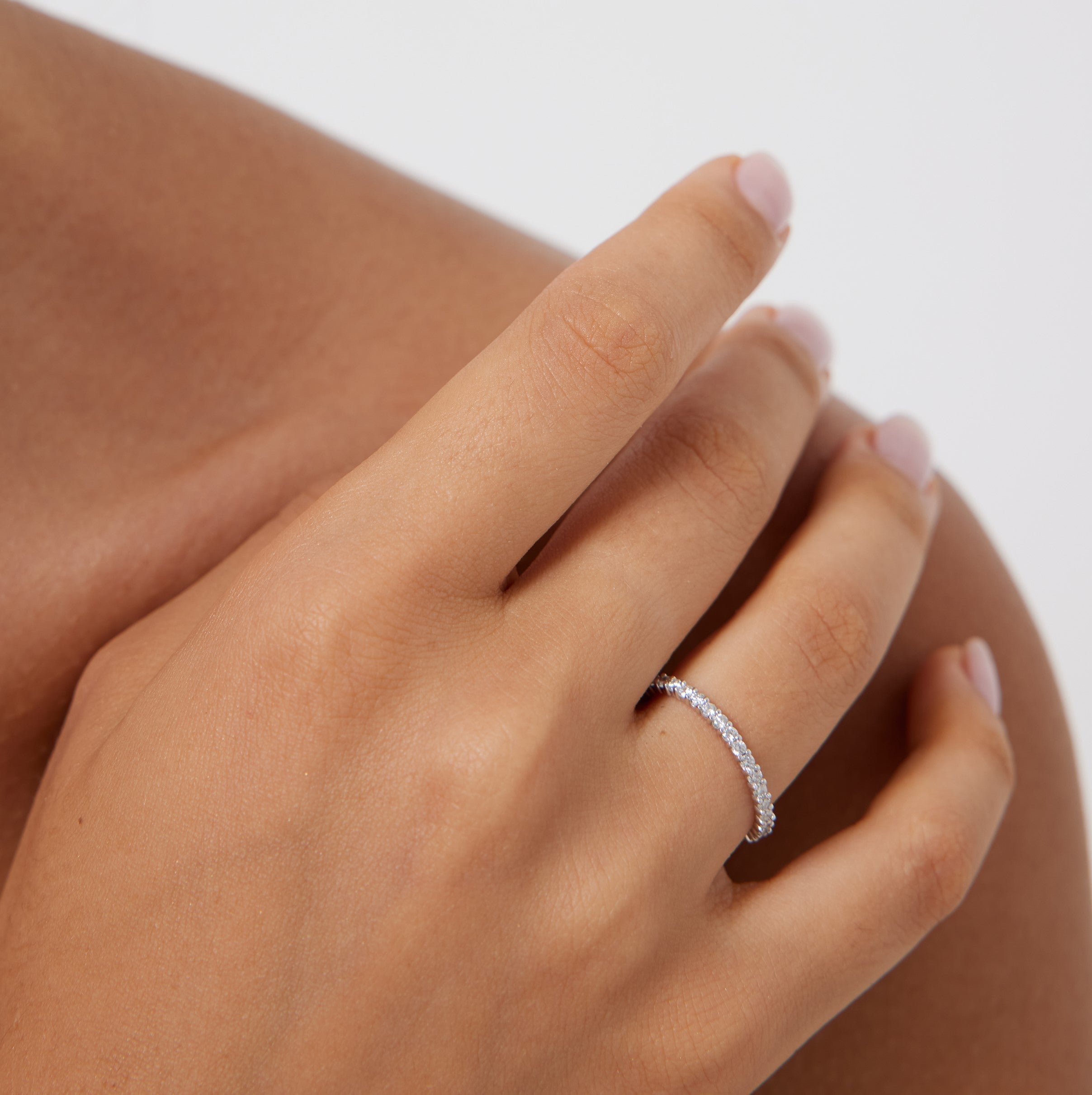 14K gold 1.9mm full eternity diamond wedding ring worn on a hand with shiny finish and sparkling diamonds.