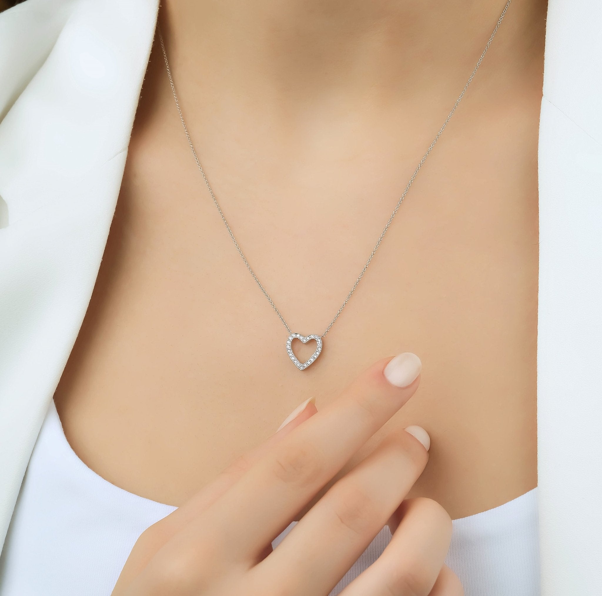 14K solid white gold dainty diamond heart necklace worn by a model, showcasing elegant design and sparkle.