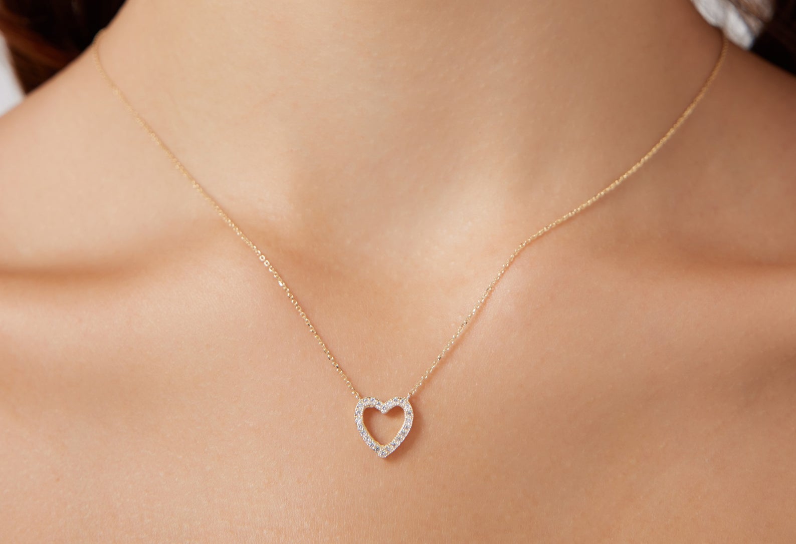 14K solid white gold dainty diamond heart necklace worn on a woman's neck, showcasing elegance and sparkle.