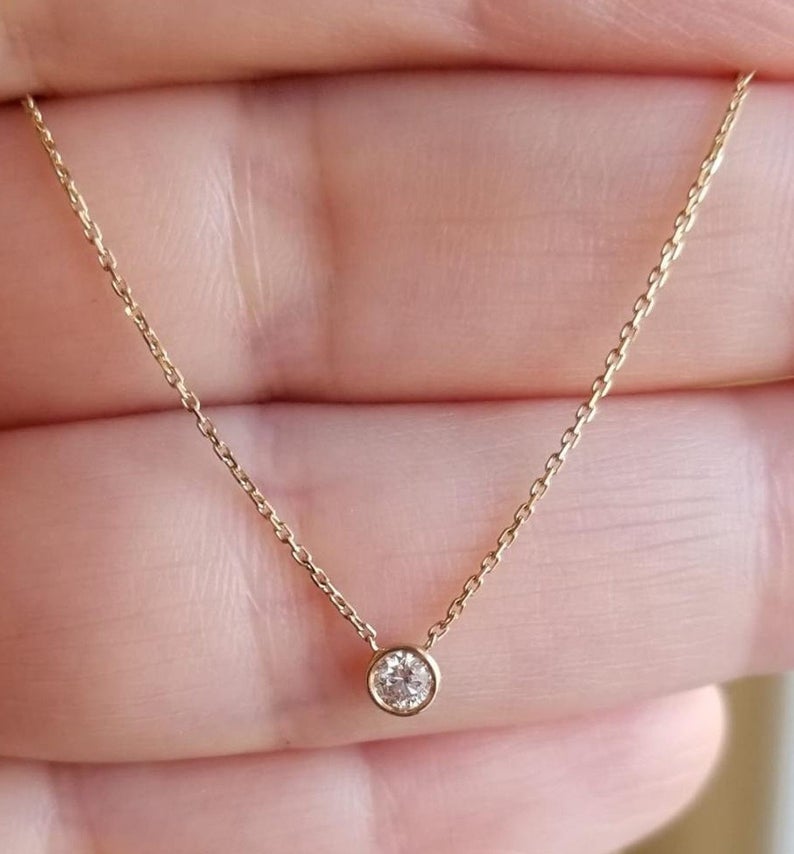 14K solid yellow gold necklace with a 0.12 carat natural diamond in a minimalist bezel setting.