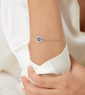 14K solid yellow gold evil eye bracelet with cubic zirconia, elegant minimalist design, worn on wrist.