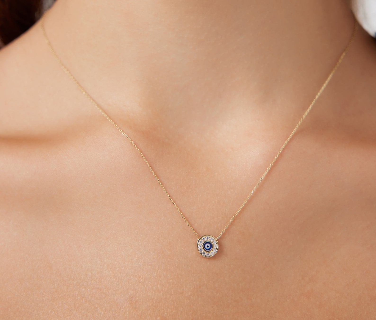 14K solid yellow gold minimalist round evil eye necklace with CZ, perfect for everyday wear, showcased on a model.