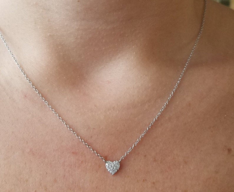 14K solid white gold minimalist diamond heart necklace worn around the neck, showcasing its delicate design and sparkle.