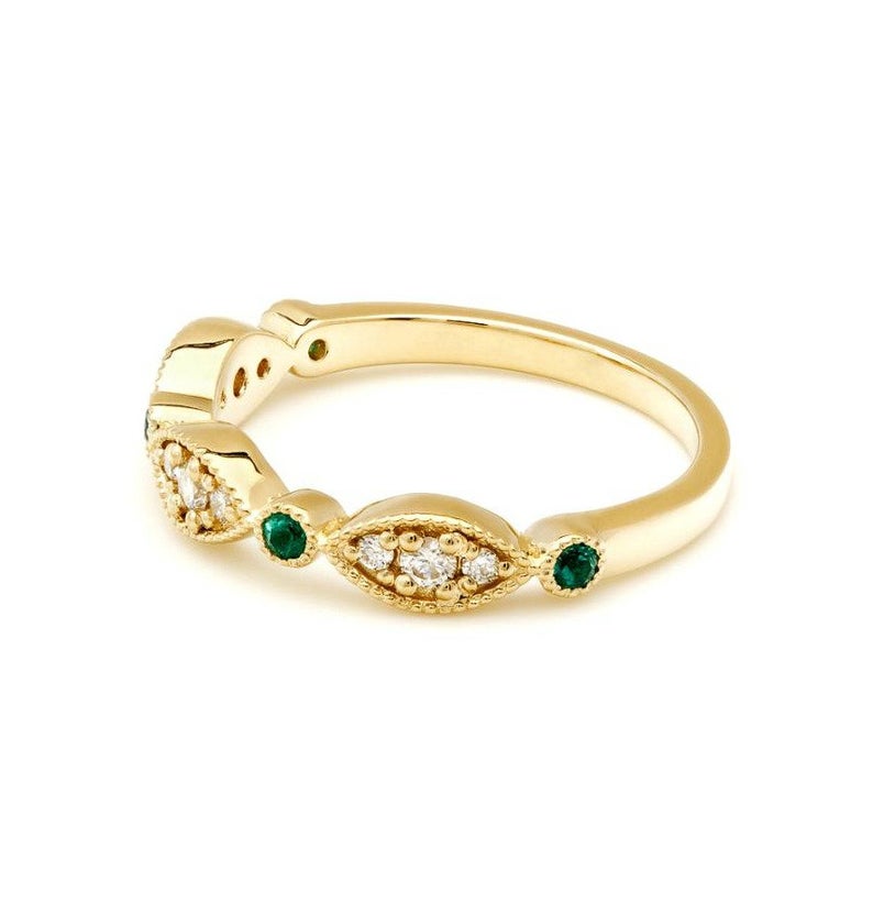 14K yellow gold ring featuring emeralds and diamonds, showcasing a shiny finish and intricate design.