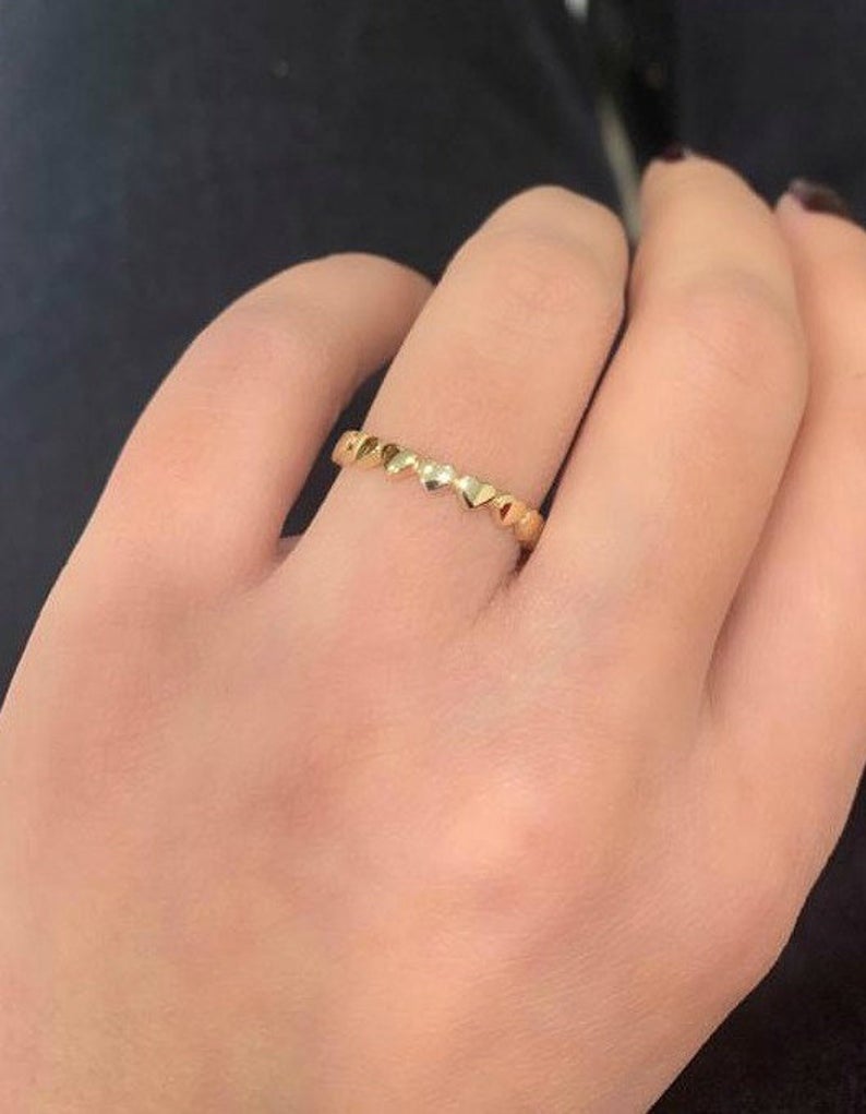 14K solid yellow gold heart ring worn on a hand, showcasing its minimalist design and elegance.