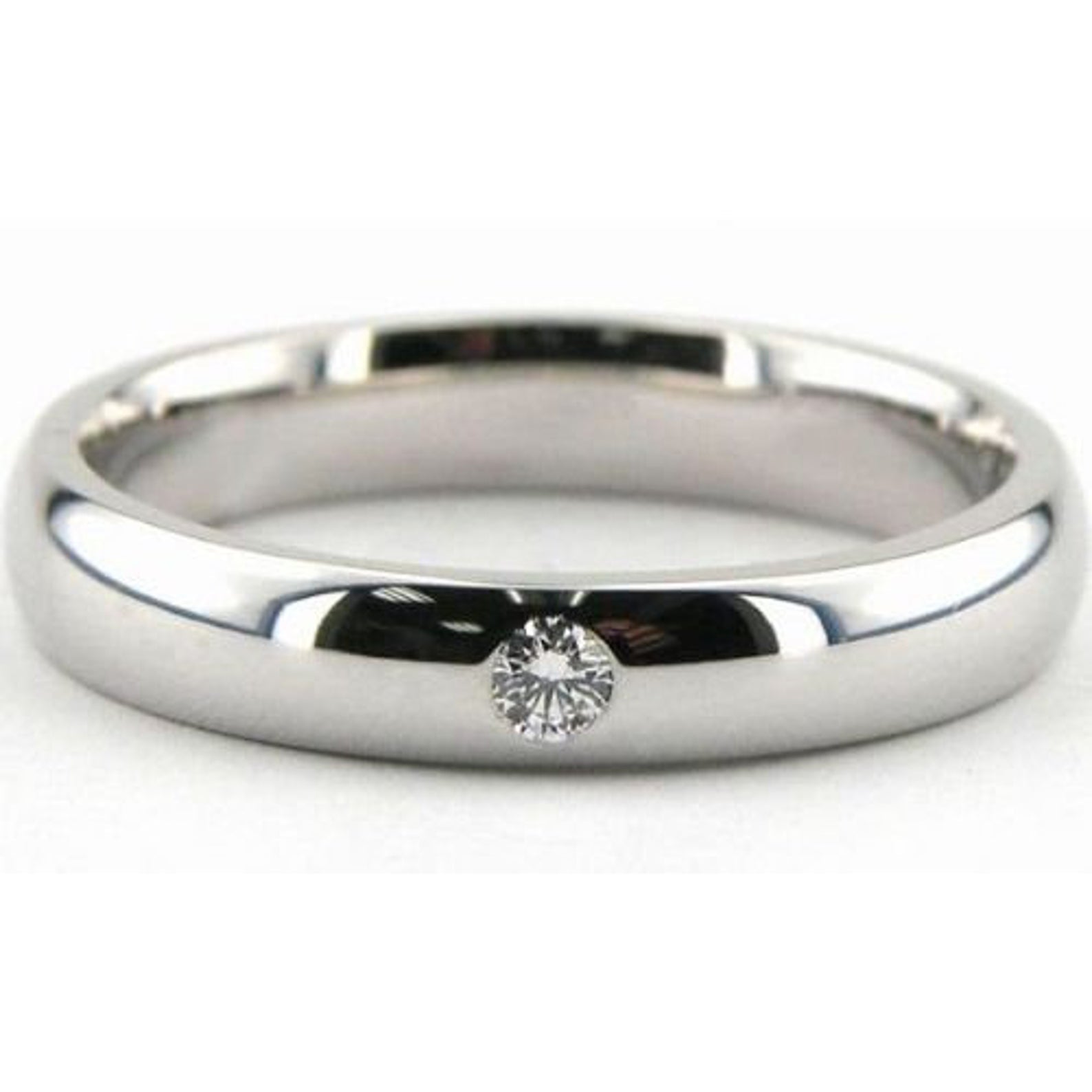 Platinum wedding band featuring a round brilliant cut diamond, 4mm wide, comfort fit, shiny finish.