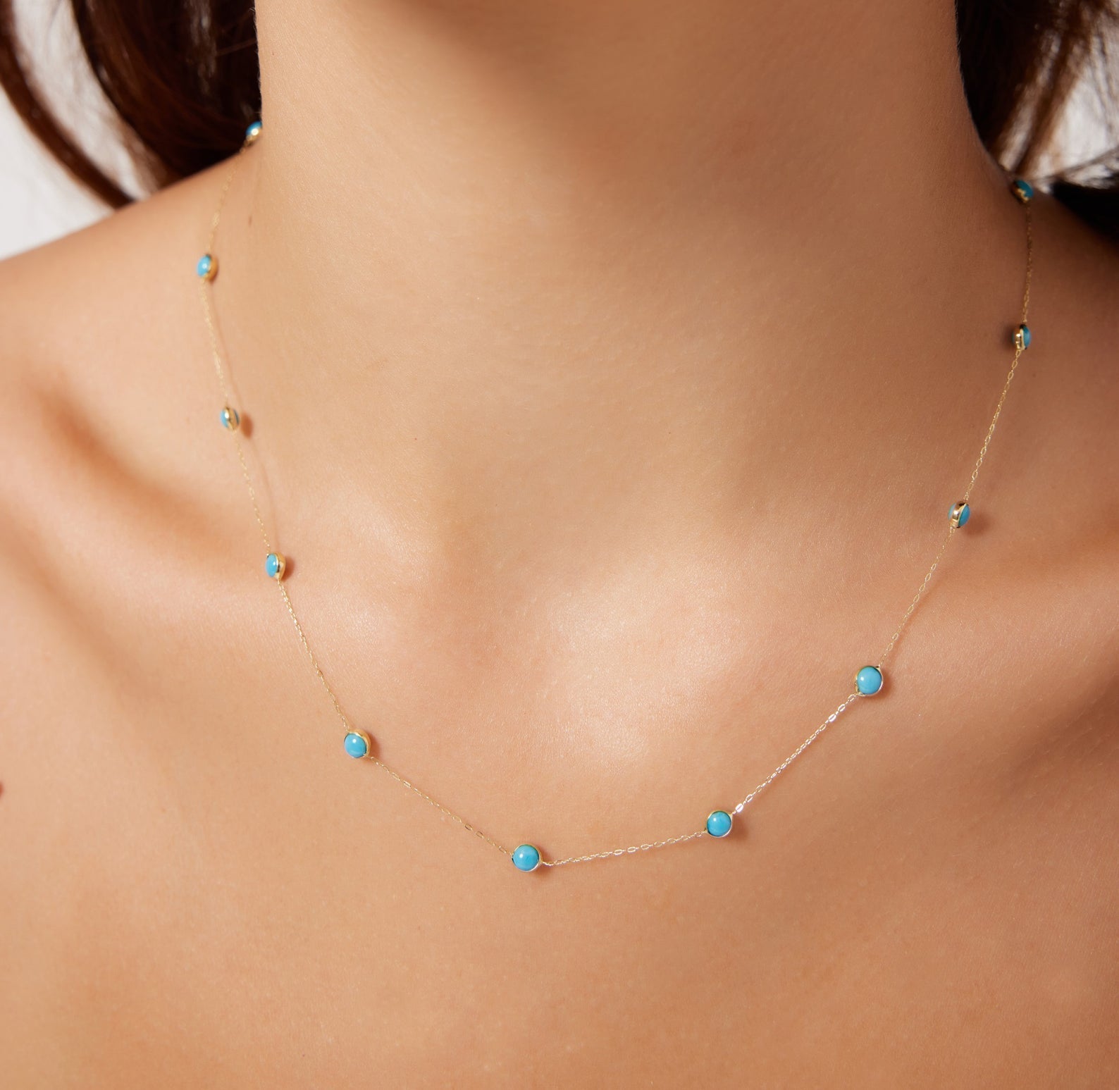 14K solid yellow gold minimalist beaded turquoise station necklace worn elegantly, showcasing vibrant turquoise beads.