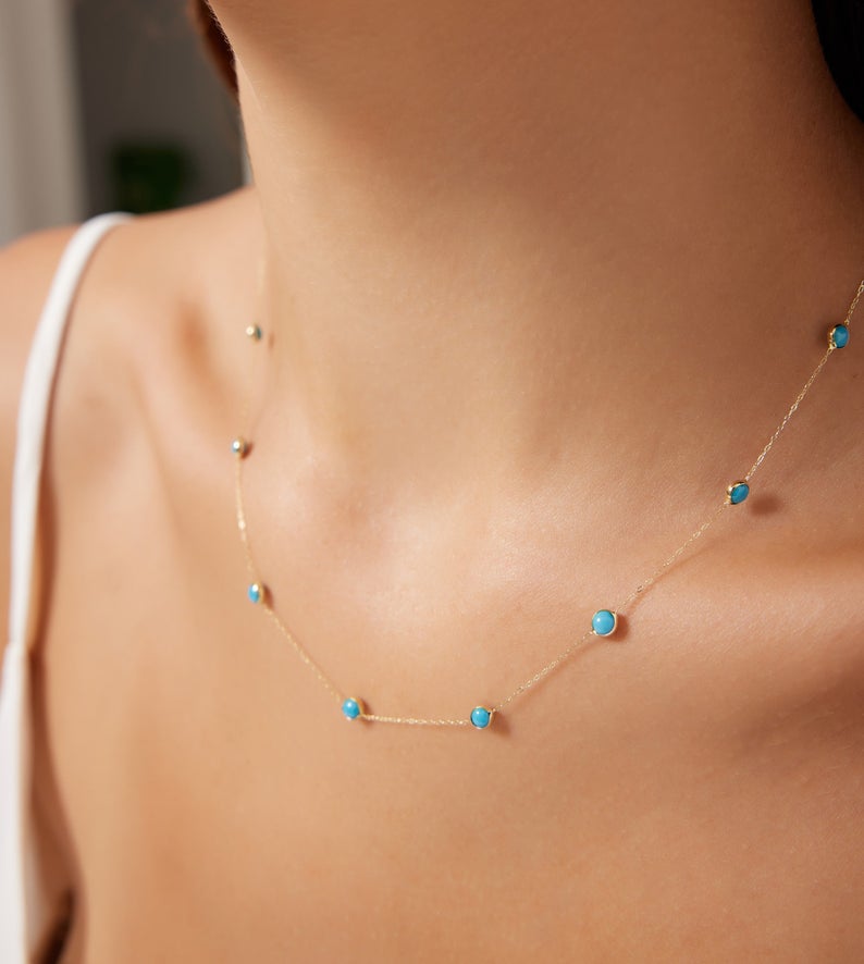 14K solid yellow gold beaded station turquoise necklace worn on model, showcasing minimalist design and vibrant turquoise stones.