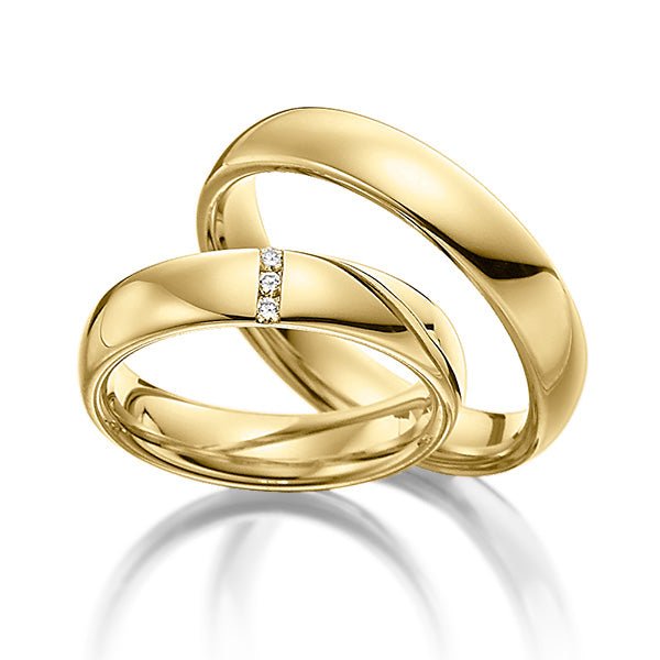 His and hers diamond wedding rings in shiny yellow gold, featuring a round cut diamond in the women's band.