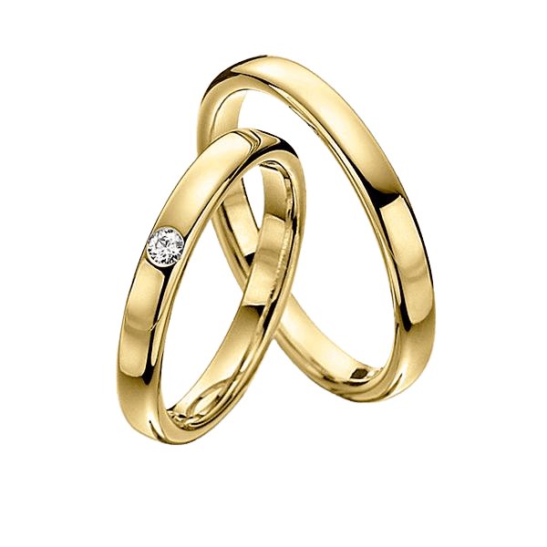 Matching wedding rings set in solid yellow gold featuring a diamond band and a smooth finish.