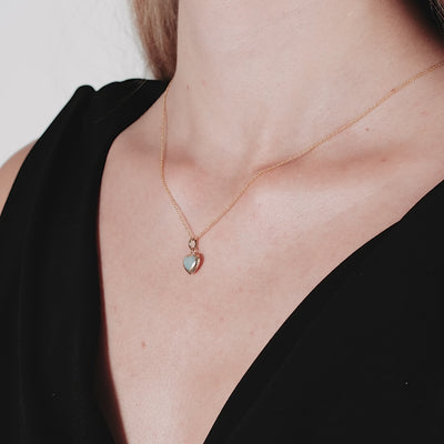 Dainty 14K yellow gold heart necklace featuring a mother of pearl pendant, perfect for everyday wear.