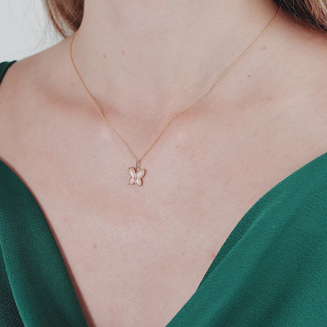 14K solid yellow gold pink butterfly necklace worn by a model, showcasing a delicate and elegant design.