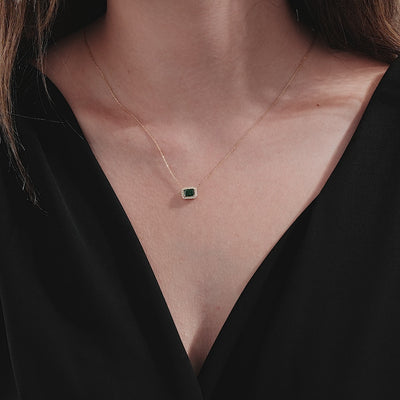 14K solid yellow gold emerald cut solitaire necklace worn by a model, showcasing elegance and simplicity.