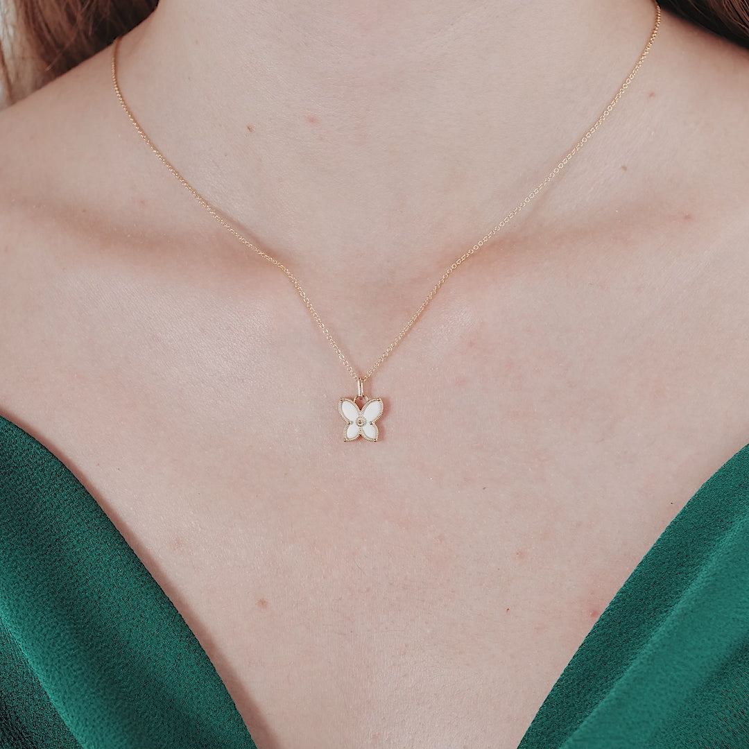 14K solid yellow gold dainty butterfly necklace worn on a woman's neck, showcasing its elegant design.