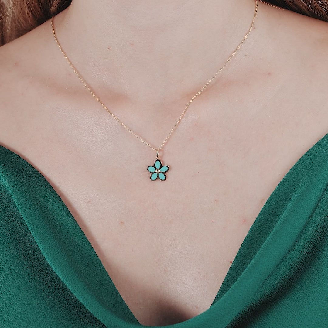 14K yellow gold turquoise daisy flower necklace worn on a model, showcasing its elegance and delicate beauty.