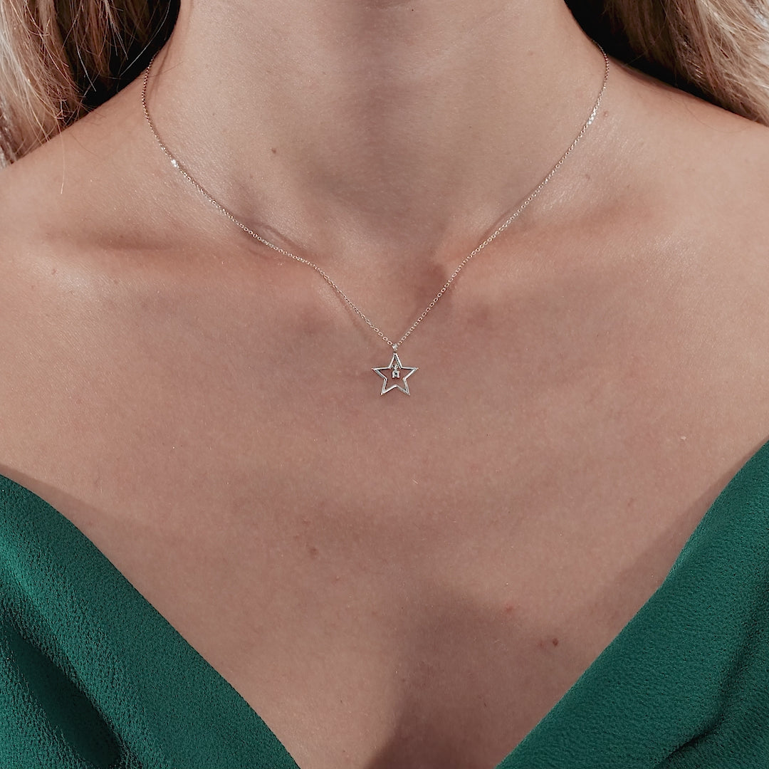 Dainty 14K solid white gold diamond star necklace worn by a woman, showcasing its minimalist design.
