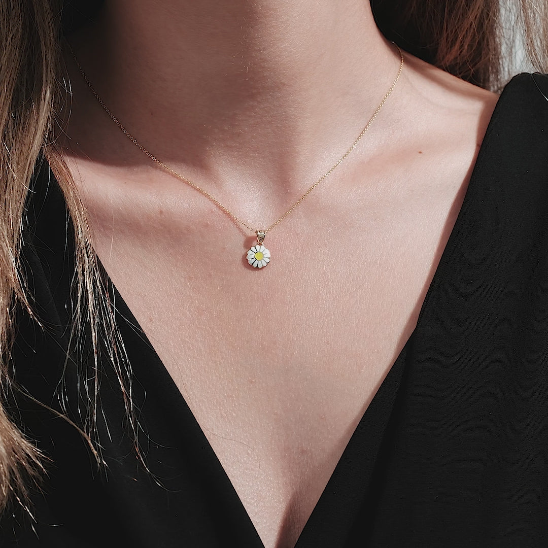 Dainty 14K solid yellow gold daisy flower necklace worn by a model, showcasing its elegance and simplicity.
