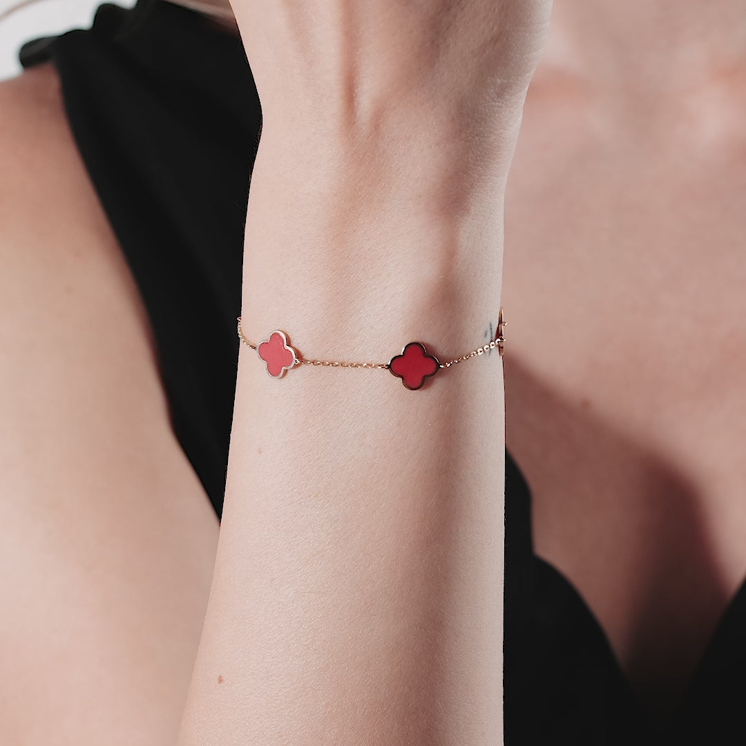 14K solid yellow gold four leaf clover bracelet with red coral accents worn on wrist