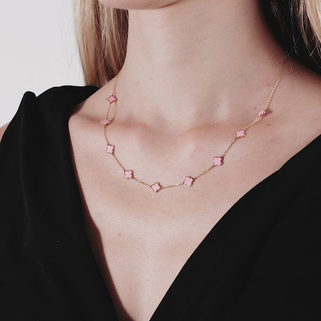14K solid yellow gold pink four leaf clover necklace worn by a model, featuring delicate stations and a chic design.