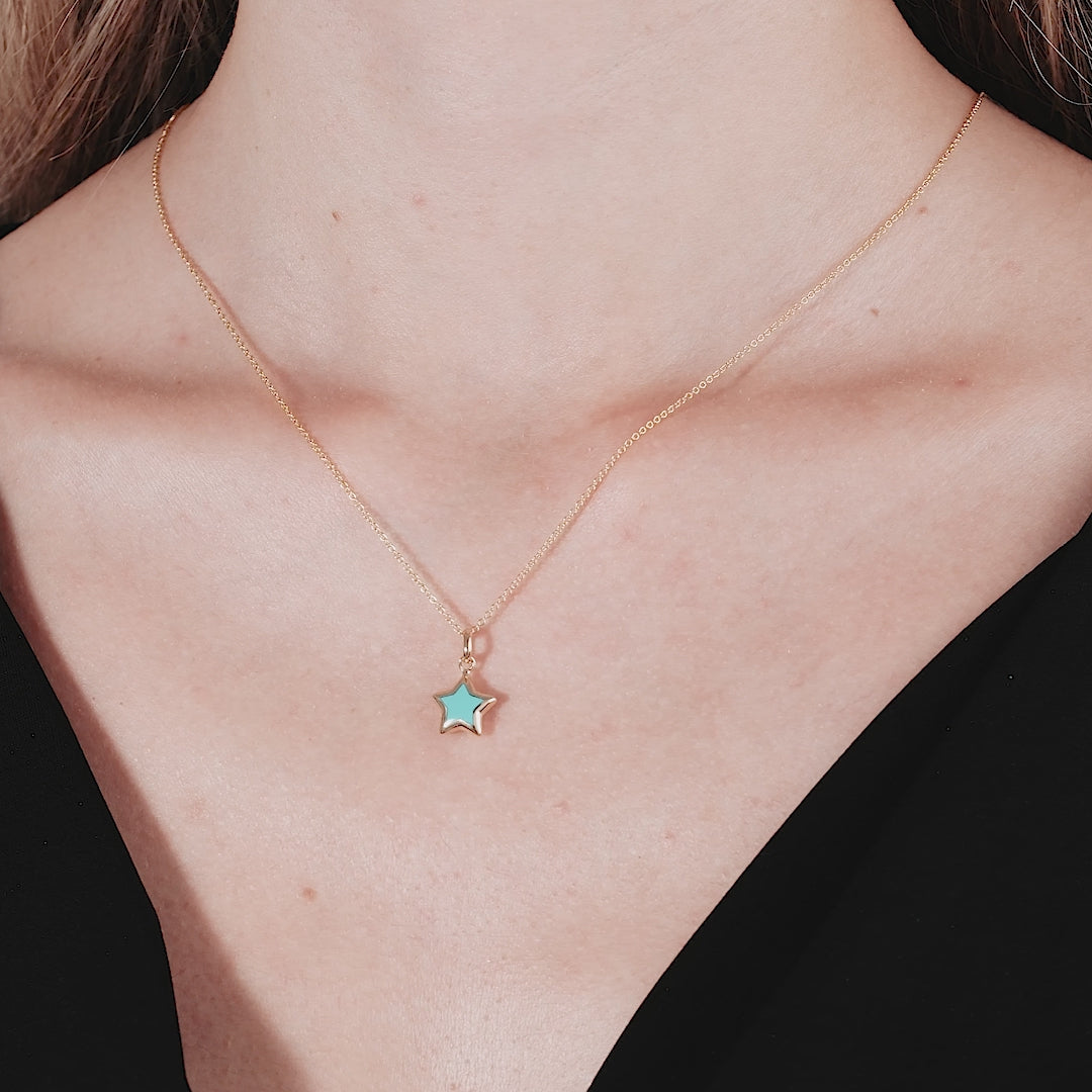 14K yellow gold minimalist turquoise puffed star necklace worn elegantly, showcasing a delicate and classy design.