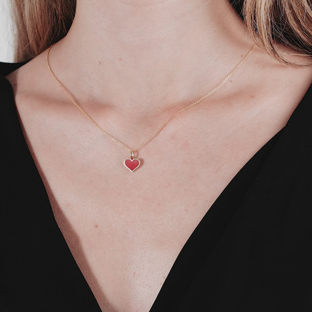 Model wearing a 14K yellow gold necklace with a red coral heart pendant, perfect for everyday elegance.